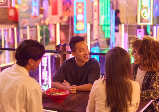 Friends sitting around a table at a raman restaurant