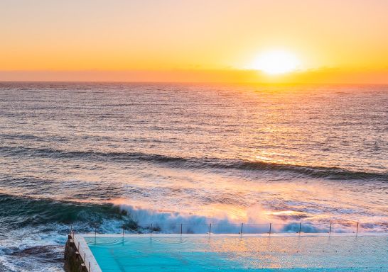 Morning sun rising over Bondi Icebergs, Bondi Beach