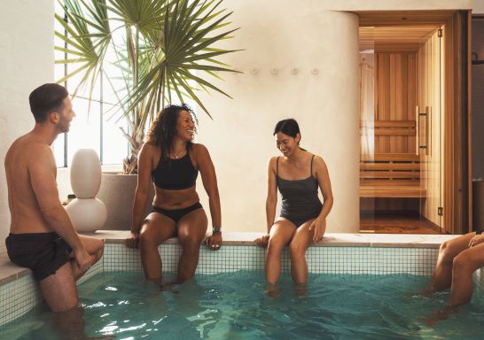 Friends enjoying mineral pool at Capybara Bathing - Credit: Declan Blackall Photography